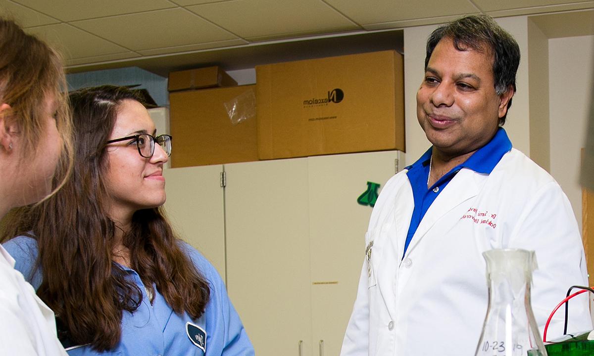 Women and man wearing lab coats 